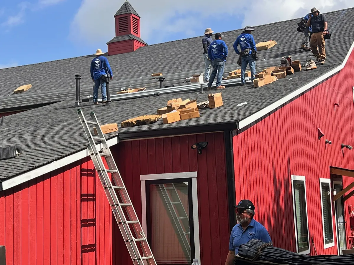 Eagle Solar Power crew at work on a red barn roof